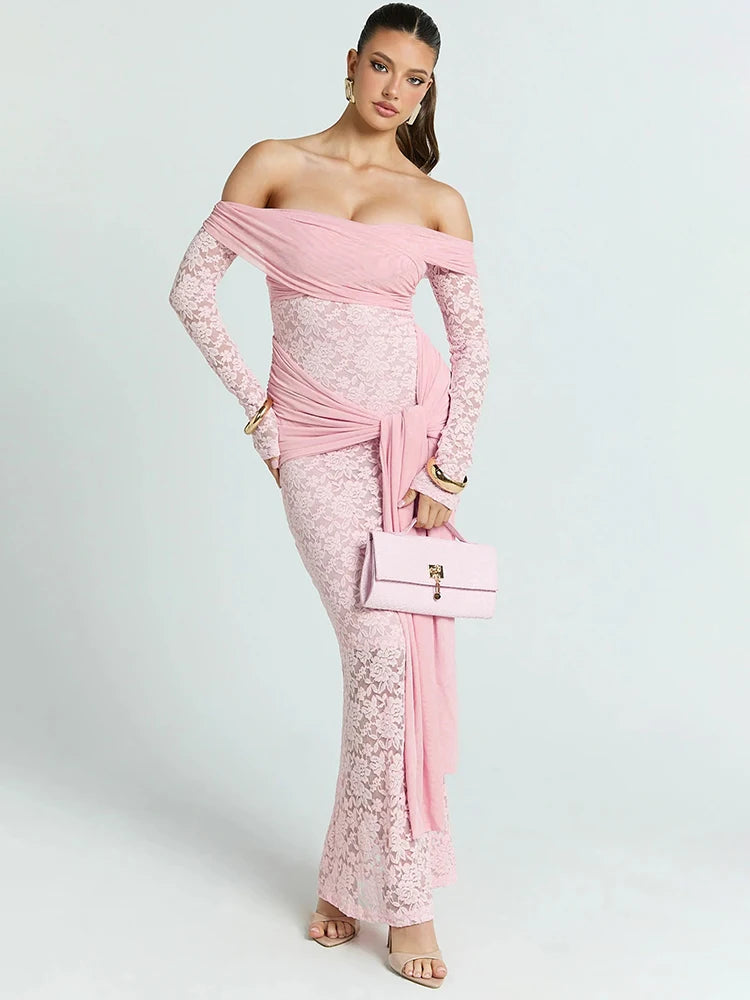 Woman wearing a pink lace off-shoulder dress holding a matching handbag 