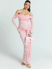 Woman wearing a pink lace off-shoulder dress holding a matching handbag 