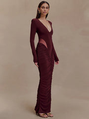 Woman wearing a burgundy evening gown with cut-out design on a beige background