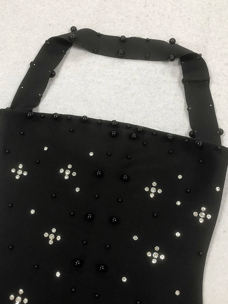Black apron with bead embellishments on a light gray background