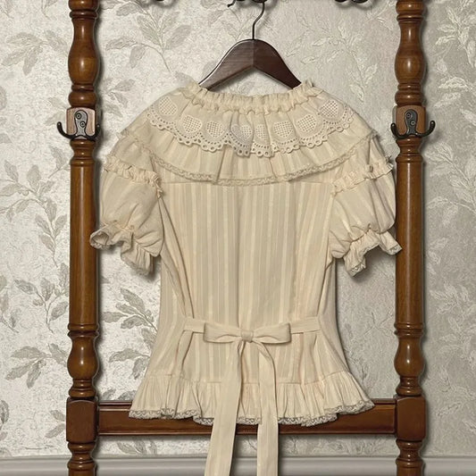 Back view of cream lace collar blouse with bow detail and short puff sleeves