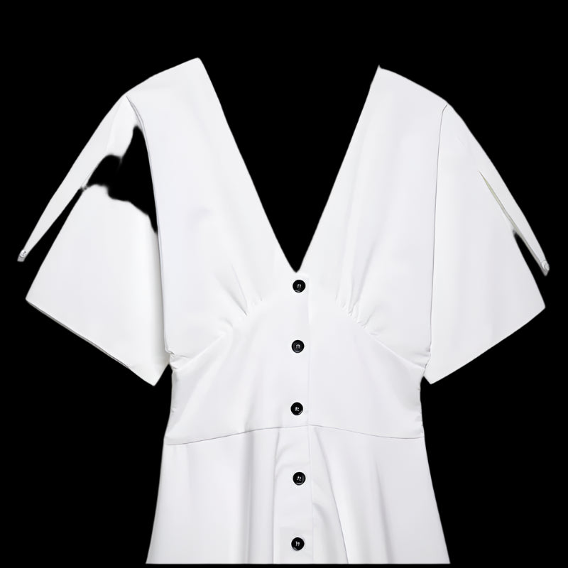 White blouse with black buttons on a light gray background