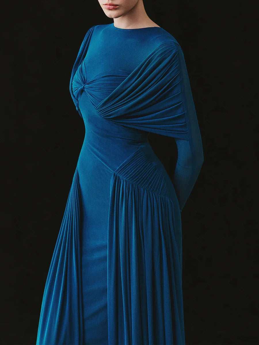 Blue evening gown with draped design on a black background
