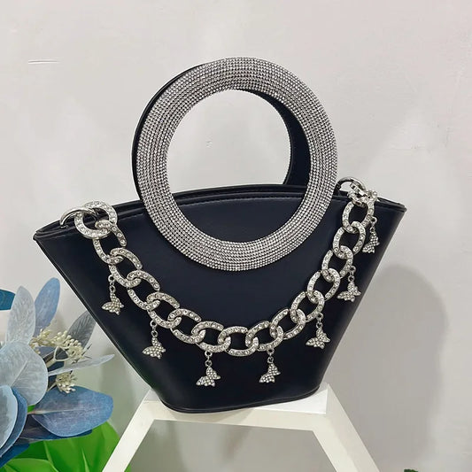 Black crystal handle trapezoid tote bag with silver chain detail