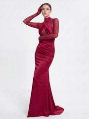 Close-up of the detailed neckline and sleeves of a ruched gown