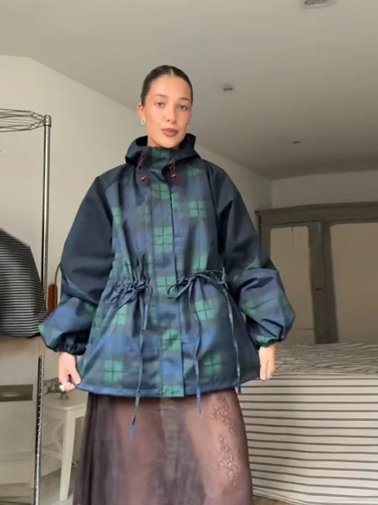 Person wearing a plaid coat in an indoor setting