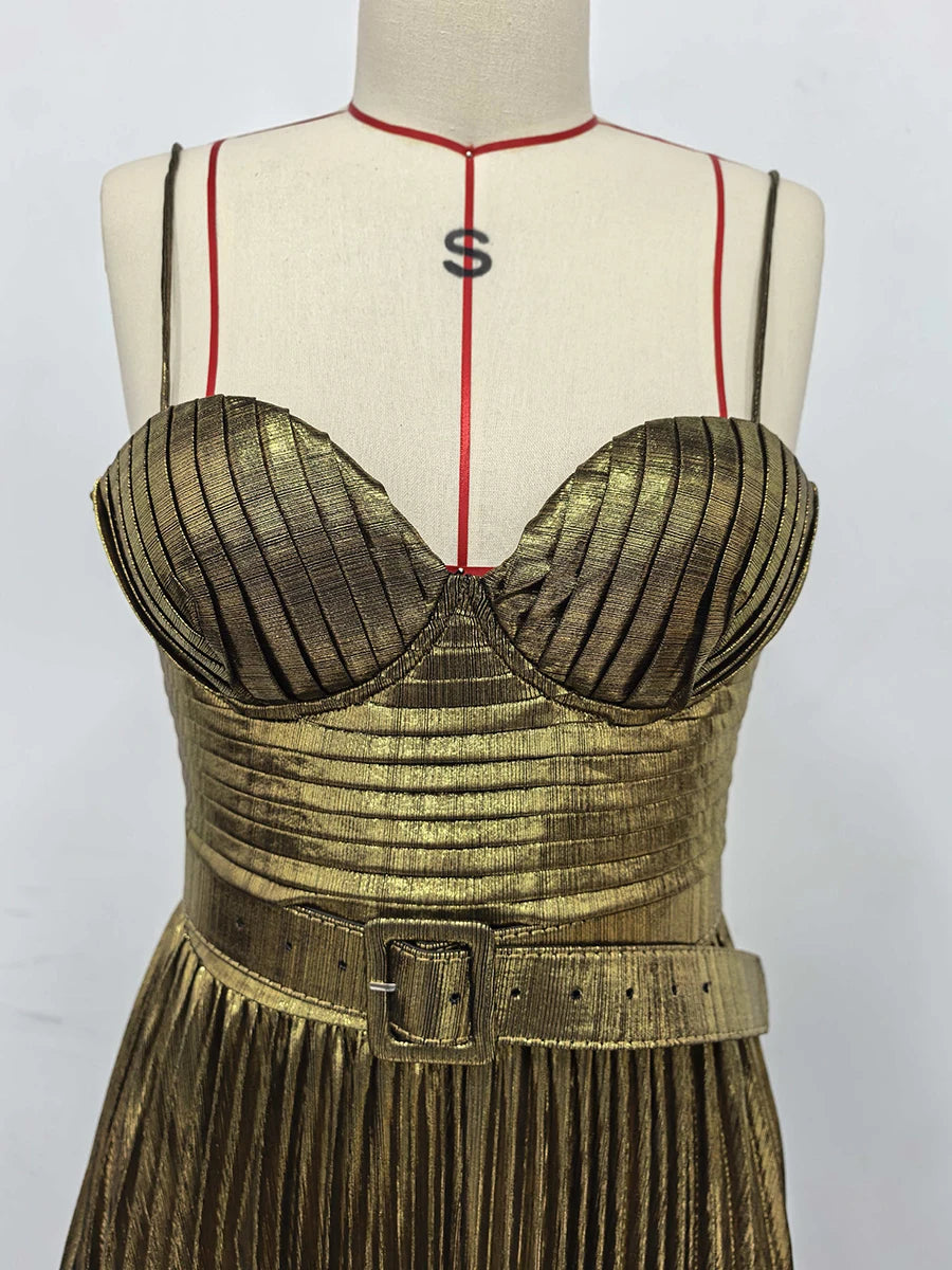 Gold dress on a mannequin with a white background