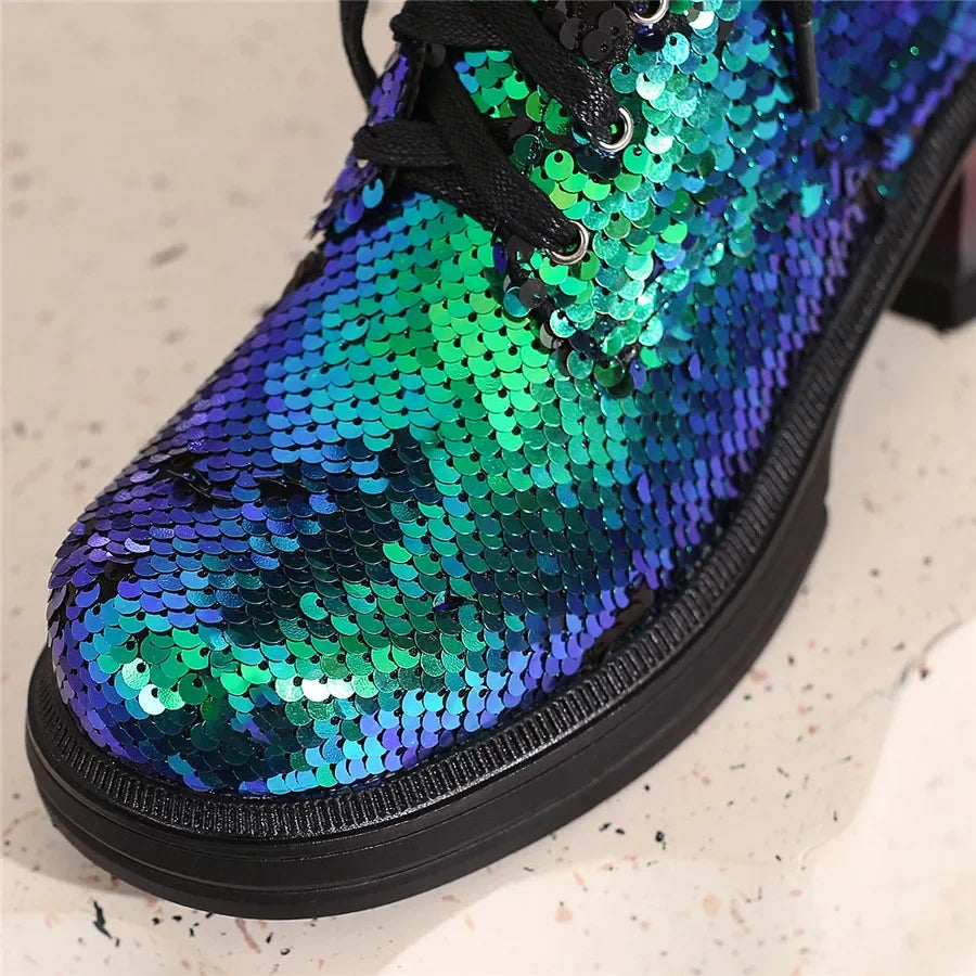 Shoe with blue and green sequin pattern on a light background