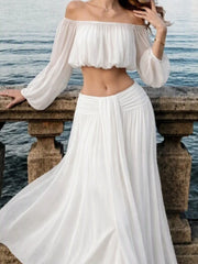 White off-shoulder chiffon crop top and maxi skirt with ruched waist detail.
