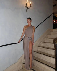Woman wearing a one shoulder cutout maxi dress on stairs