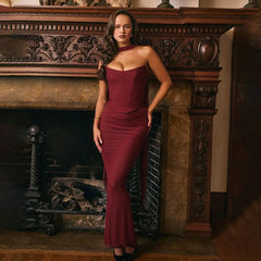 Model wearing wine red ruched strapless floor-length gown with scarf collar.