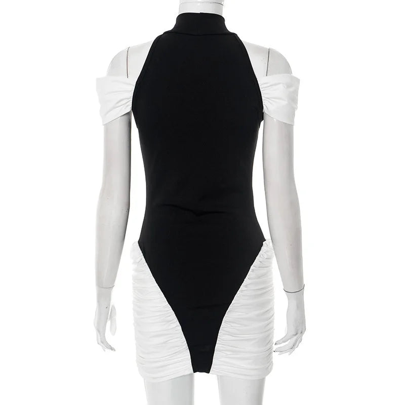 Mannequin wearing a black and white dress with ruched sleeves and sides on a white background
