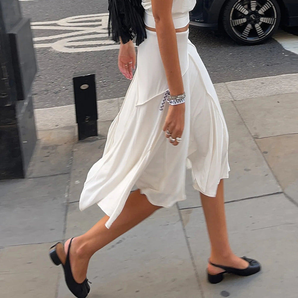 A person walking in an irregular split midi skirt