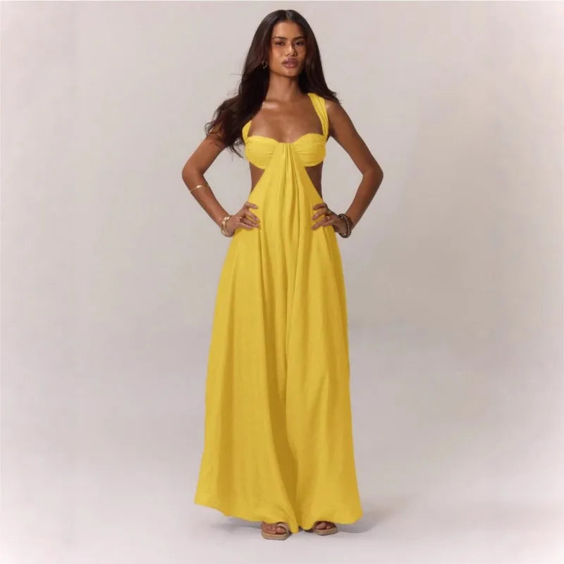 Woman wearing a yellow jumpsuit against a plain background