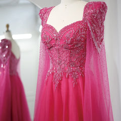  Close-up of the beadwork and elegant cape sleeves on the fuchsia Sharon Said gown. Golden Atelier 4