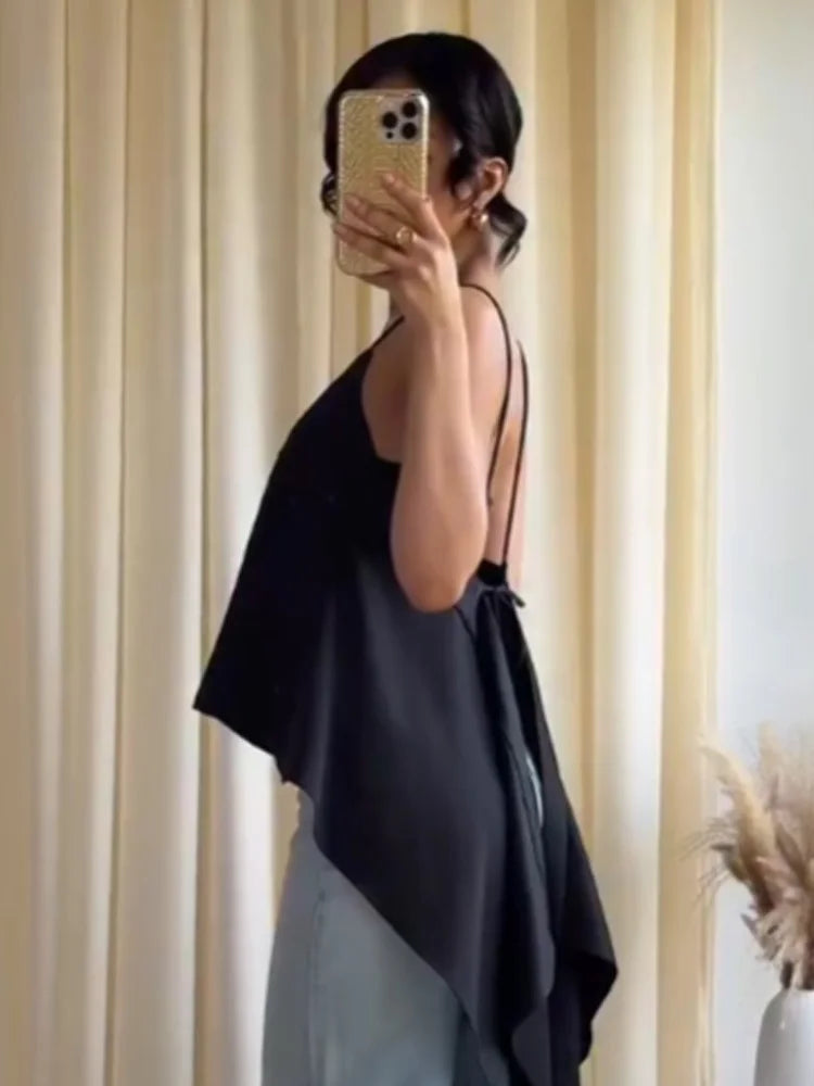 Person wearing a black and gray dress standing in front of a mirror.