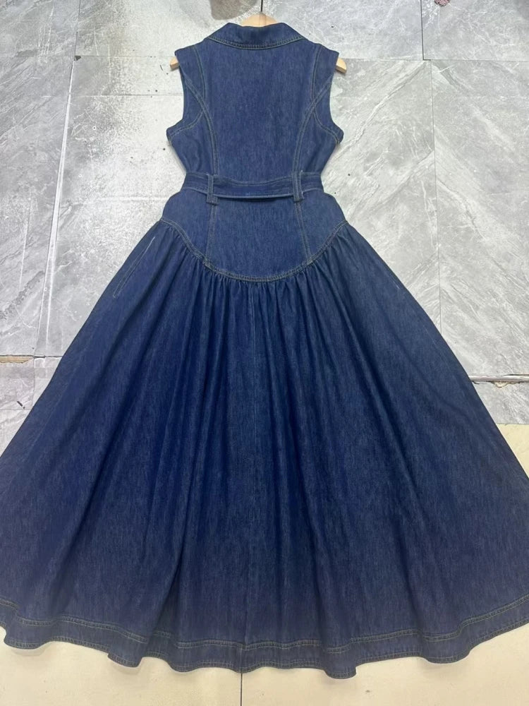 Denim dress on a hanger against a tiled floor background