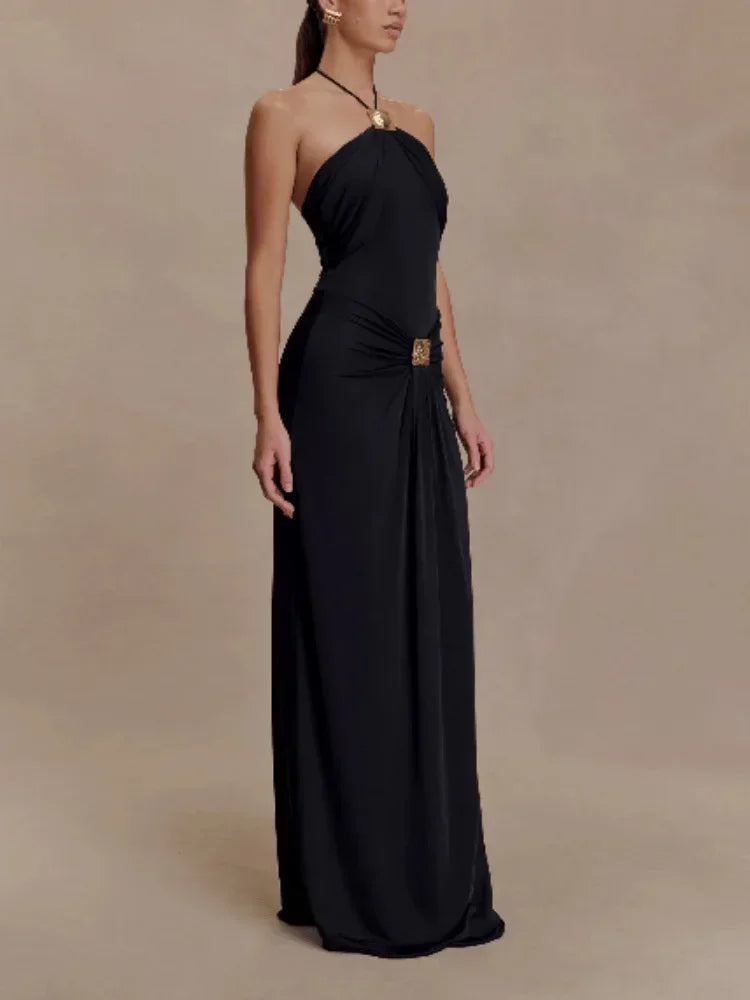 Black strapless gown on a model against a beige background