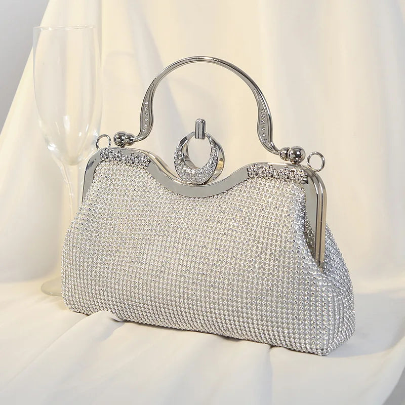 Silver crystal-encrusted clutch bag with ring handle