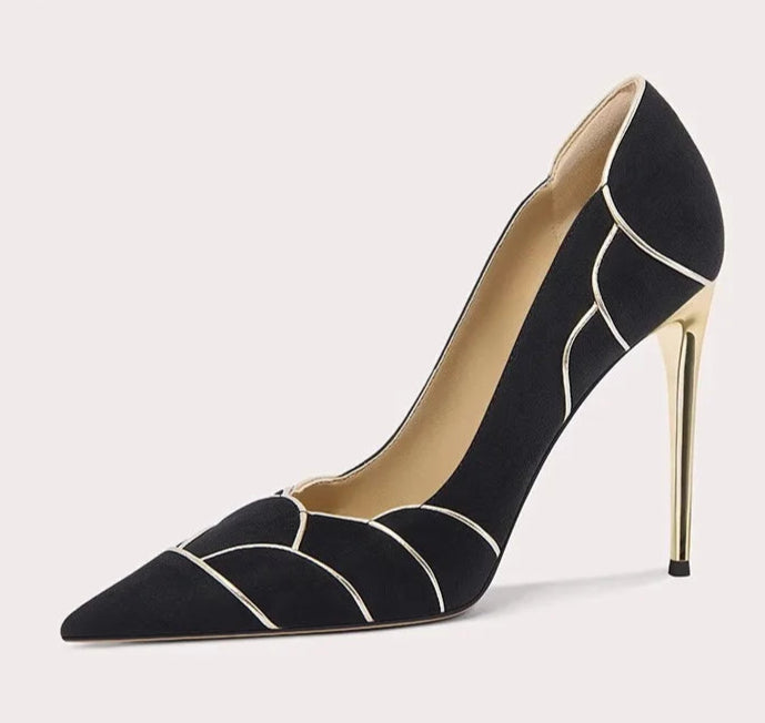Black high-heeled shoe with geometric design on a light gray background