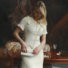 Woman in a white dress standing in a restaurant setting