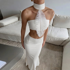 Close-up of the feather embellishment on a halter neck tube top and skirt set