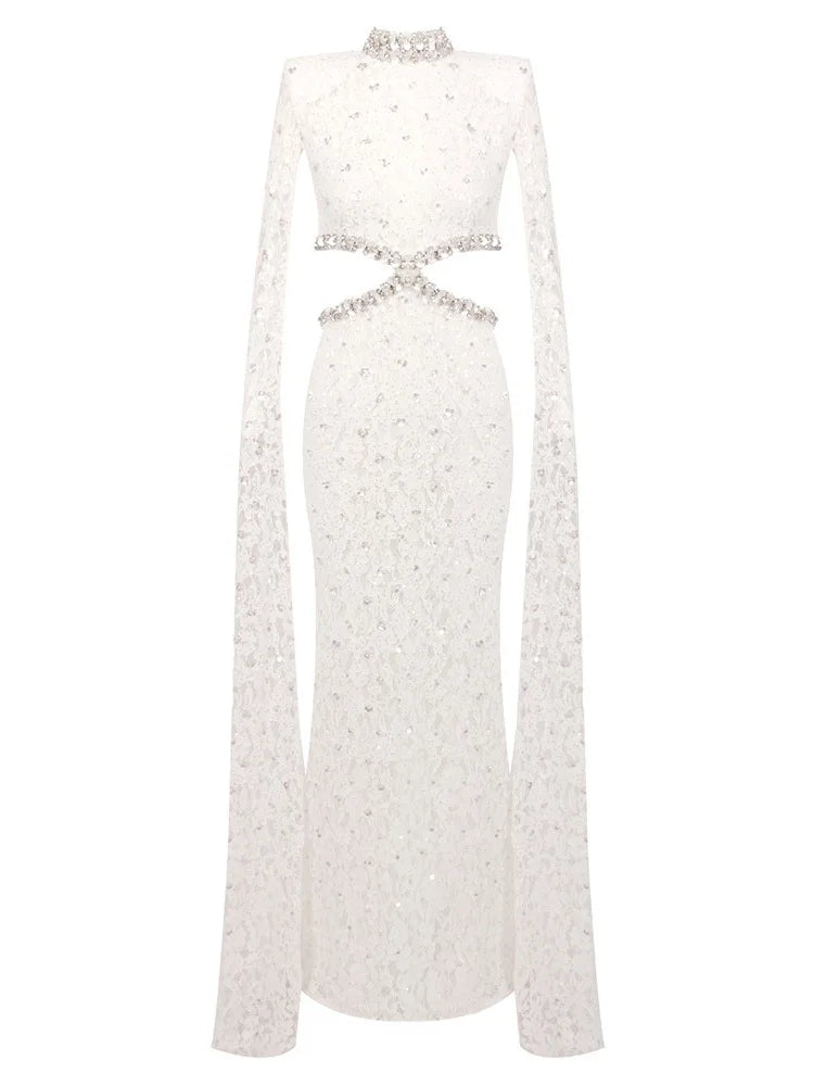 White long-sleeve dress with embellishments on a white background