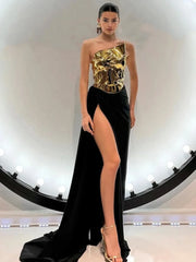 A model wearing a glamorous strapless gold top and high-slit black skirt set, perfect for evening events. Golden Atelier 3