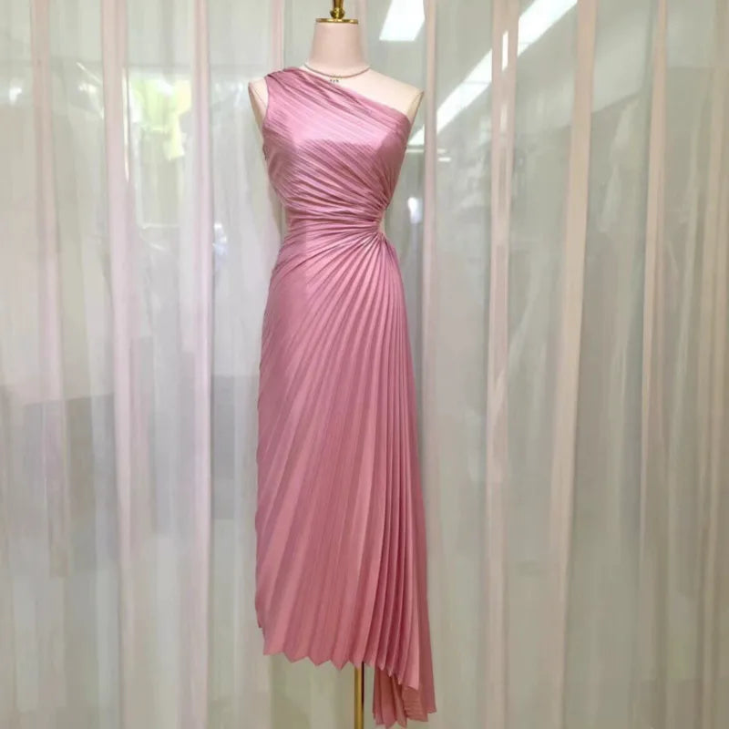 Pale pink asymmetrical one-shoulder gown on a mannequin.