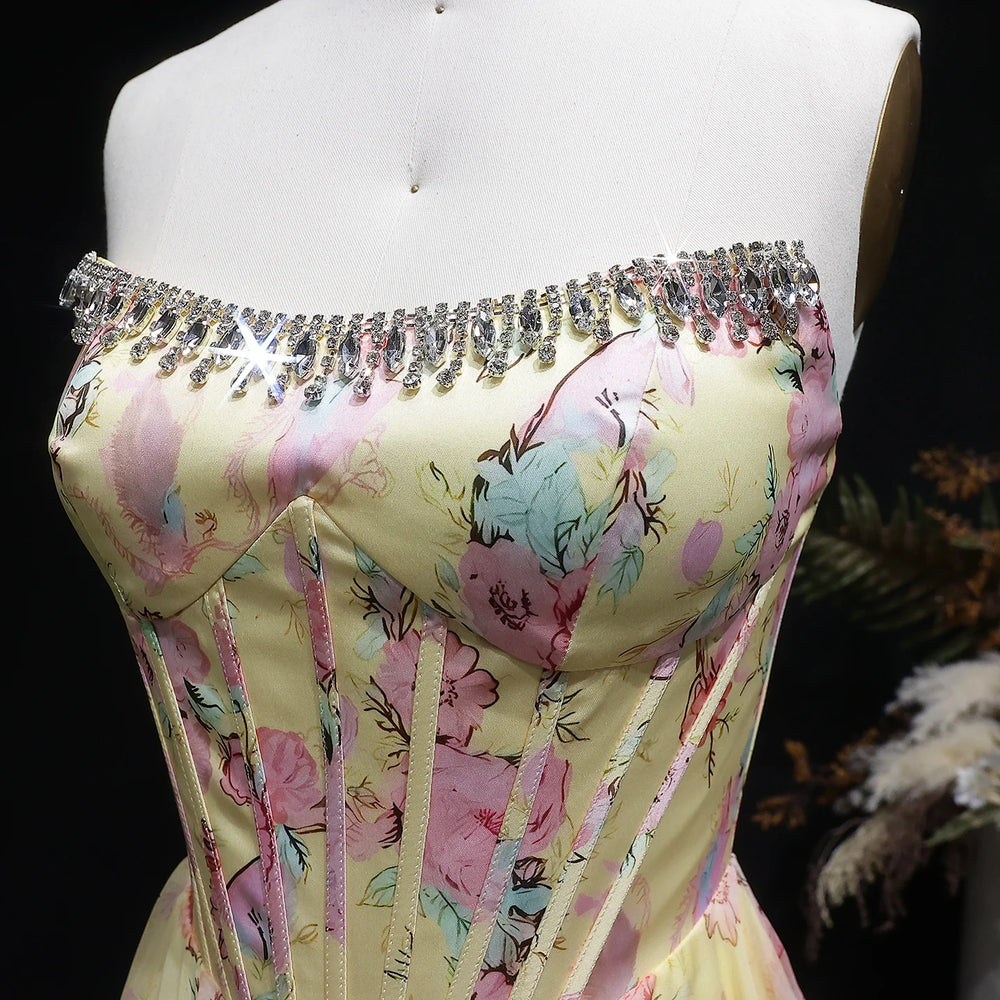 Floral off-shoulder dress with rhinestone embellishments on a mannequin against a dark background.