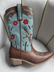 Brown and teal cowboy boot with floral and bird design on a white background