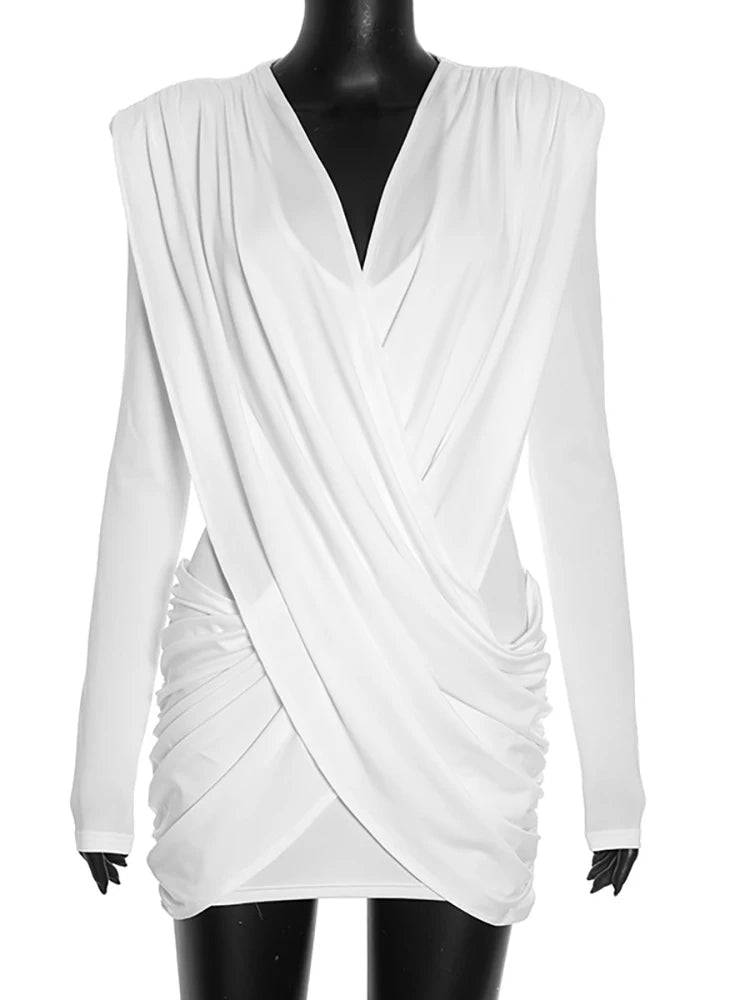 White draped dress on a mannequin against a white background
