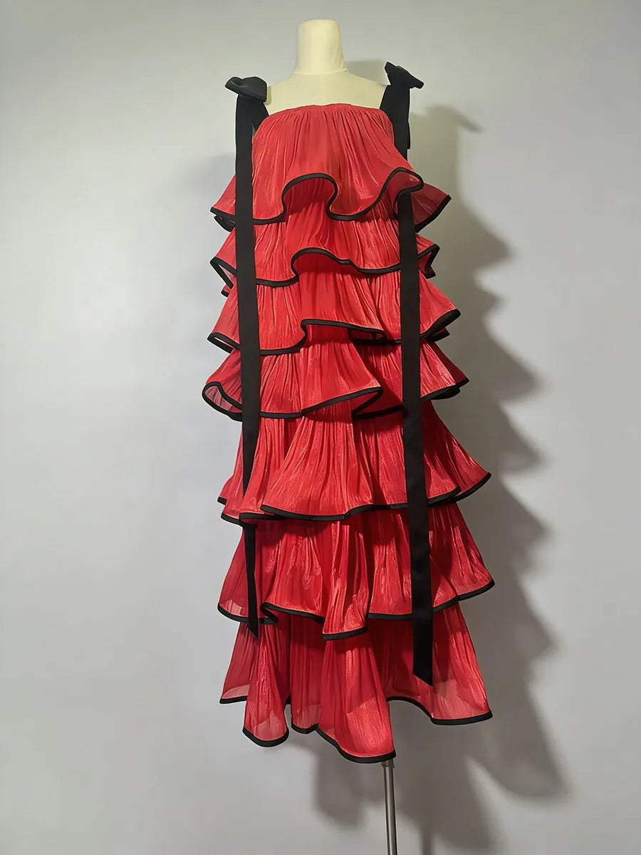 Red ruffled dress with black trim on a mannequin against a white background