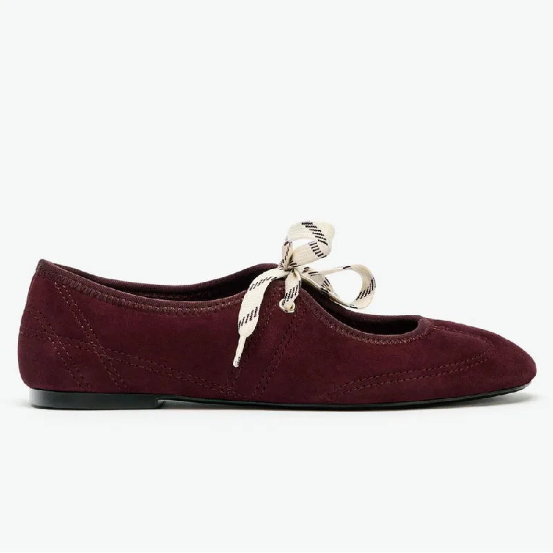 Side profile of burgundy faux suede round toe ballet flats with lace-up detail.