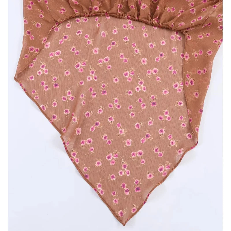 Floral-patterned fabric with pink flowers on a brown background