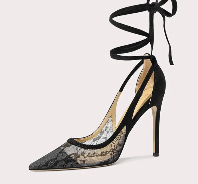 Black lace high-heeled shoe with ribbon detail on a white background