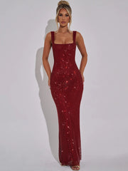 Woman wearing a burgundy sequin dress against a white background