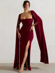 Model wearing a flowing cape sleeve maxi dress with a high split. 2