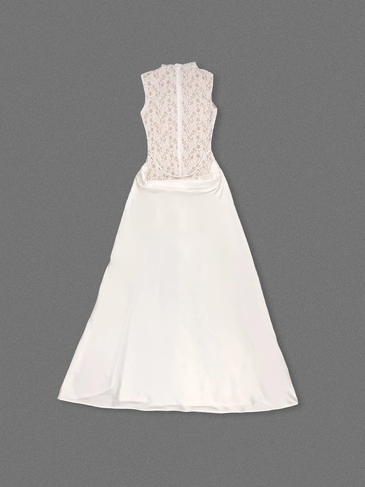 White dress with lace detailing on a gray background