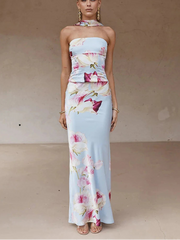Woman wearing a floral strapless dress against a neutral background