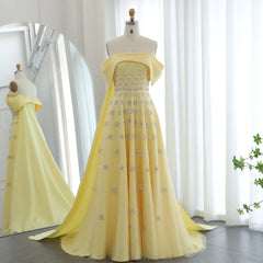 Mannequin  displaying the yellow satin evening gown with cape, showcasing its flattering silhouette and vibrant color. Golden Atelier 4