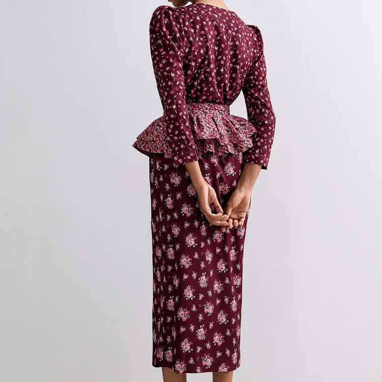 Maroon floral dress with ruffled peplum top on a plain background