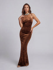 Woman wearing a brown velvet dress on a gray background