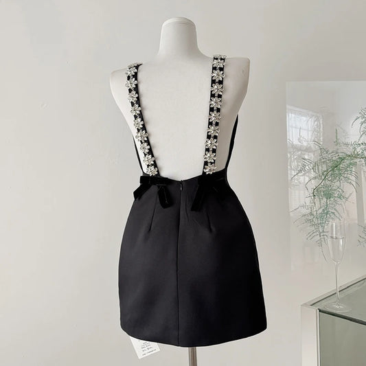 Black mini dress with crystal flower embellished spaghetti straps and velvet back bows