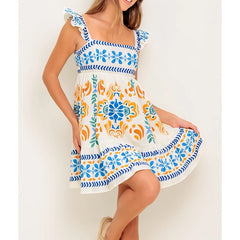 Woman wearing a colorful floral dress with a white background