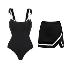 Black and white one-piece swimsuit with adjustable straps and matching skirt set, white background.