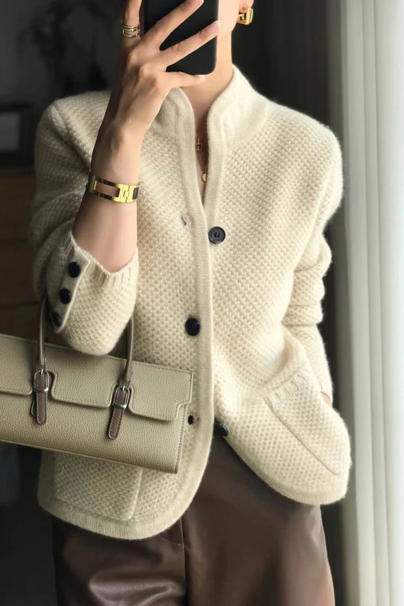 A woman wearing a luxurious Beige 100% cashmere cardigan, showcasing its elegant drape and warmth. Golden Atelier 1