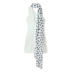 White sleeveless top with a polka dot scarf on a white background
