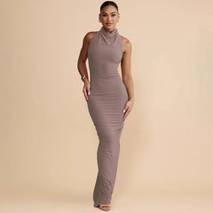 Woman wearing a brown dress against a beige background