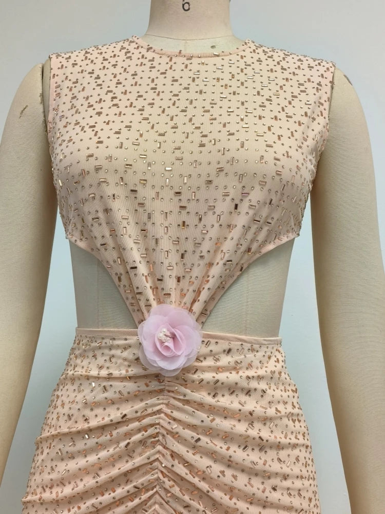 Mannequin wearing an apricot dress with a floral detail on a light gray background